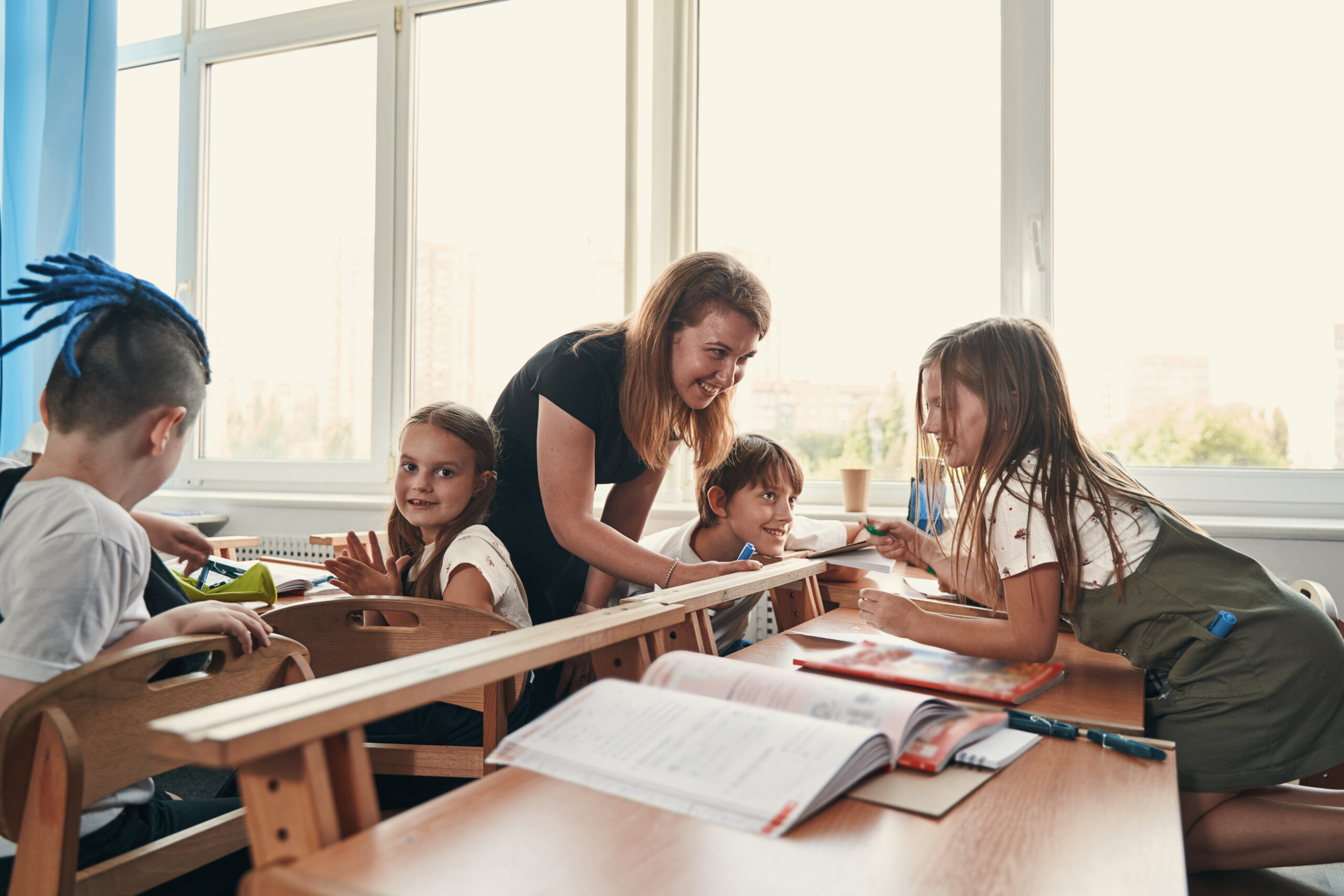 Clever kids sharing ideas with amazing teacher